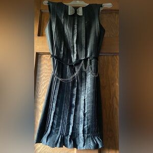 Julie Haus Elegant Black Pleated Cocktail Dress with Chain Detail.